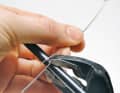 Wrap the spiral around a rod: Fix the wire and tube with pliers, then make two coils by hand