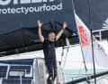 Fabrice Amedeo throws his arms up as he crosses the finish line.