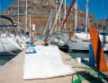 Work on the ship keeps the crew constantly busy en route. Here, for example, all the sails of the "Inti" are thoroughly inspected and repaired before heading out into the ocean
