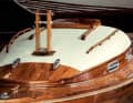 The dinghy cruiser has a varnished running deck made of solid mahogany and a cabin superstructure planked with softwood and then covered with canvas and painted white