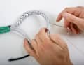 The two Dyneema cores are very smooth, so the inner core can easily slip. To prevent this from happening during the next steps, the braids are sewn together with a few stitches