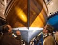 Inspection in dark winter storage. Classic sailing is still a vague idea for the new owners