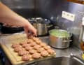 The crew of a sea rescue cruiser cook for themselves, as shown here with meatballs and beans.
