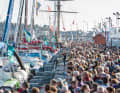Thousands of interested people crowd the harbour facilities