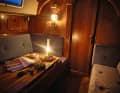 Cosy atmosphere: outside the rain lashes horizontally across the deck, inside the paraffin lamp provides pleasant light and warmth