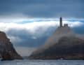 The lighthouse at Cabo Vilán rises almost eerily above the foggy and cloudy Costa da Morte