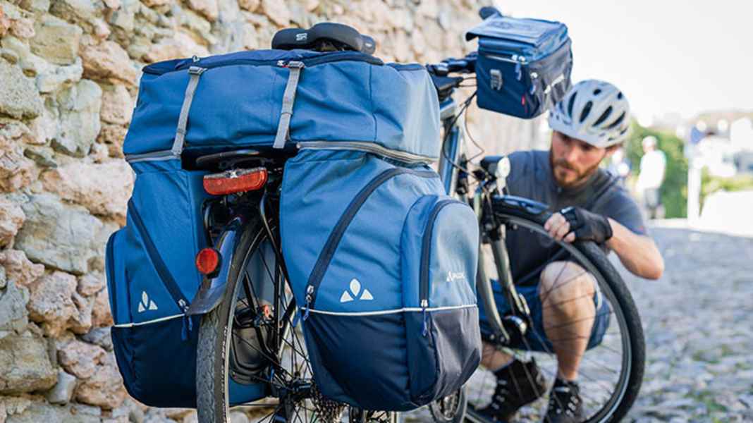 Simply hire bike bags, tents and the like instead of buying them?