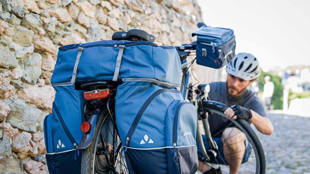Simply hire bike bags, tents and the like instead of buying them?
