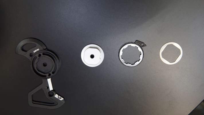   The friction clutch on the rear derailleur cage works with a freewheel mechanism and is designed to tighten the chain so that it rattles less on rough descents.