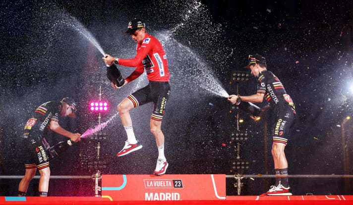 Exuberant joy on the podium. Jonas Vingegaard and Primoz Roglic celebrate the surprise winner Sepp Kuss (centre). 21st stage