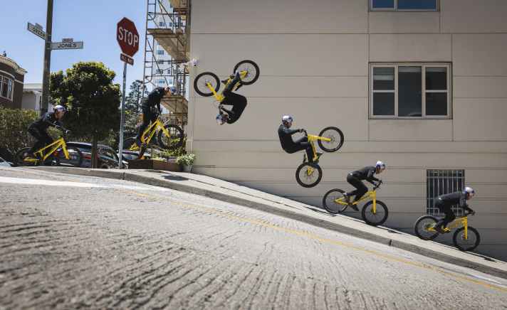 Danny performs spectacular stunts like this front flip on the streets of San Francisco on his trial bike.