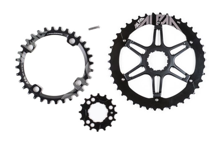   So sieht das komplette Umbau-Kit von Commencal aus: Links oben das neue Kettenblatt, rechts das 42er-Ritzel, dazwischen die Stellschraube für das Schaltwerk und unten das 16er-Ritzel.