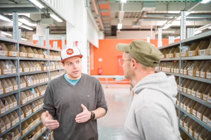   Fünfzehn Jahre ist es her, dass MTB-Freak Philipp Simon (li.) sein Maschinenbaustudium geschmissen hat, um bei Bike Components zu arbeiten. Heute ist er Chef von 196 Mitarbeitern. Hier erklärt er BIKE-Reporter Henri Lesewitz die Finessen des Warenlagers.