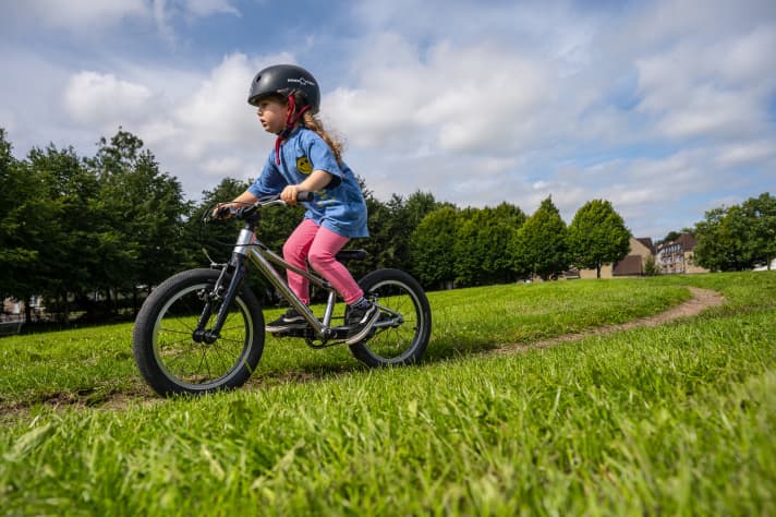The first few rides on a child's bike still require full concentration.