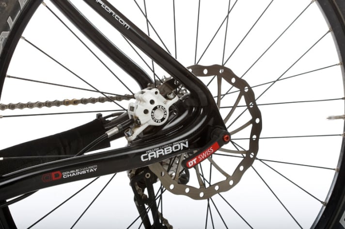   A post mount brake adapter sits in the carbon rear triangle. The X12 thru-axle is designed to provide stiffness and simplify wheel changes.