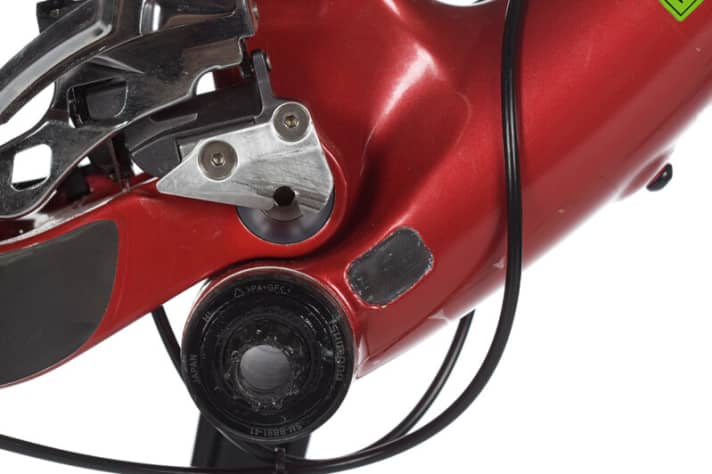   The use of the direct mount front derailleur has made the rear triangle even more compact. The front derailleur moves with the swingarm - this provides clearance. The pivot bolt can be reached through the hole in the plate without unscrewing the front derailleur.