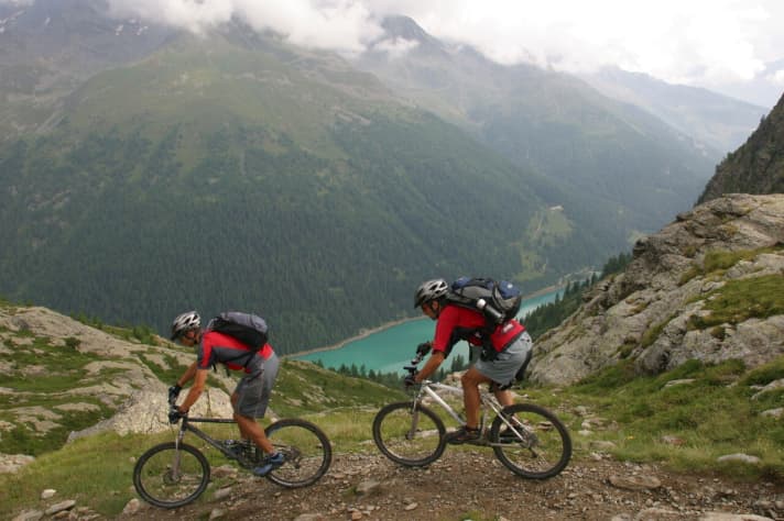   Alpine crossers at the Montozzo ridge, Lago Pian Palü in the background.
