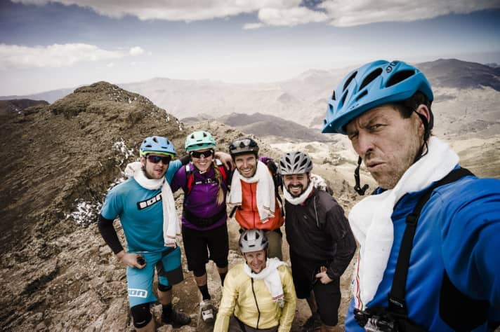   A group of bikers around adventurer and star photographer Dan Milner in Ethiopia. All wearing helmets, of course!
