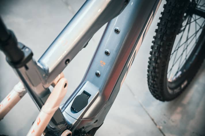   The lock for the battery cover is located under a small flap near the bottom bracket, as shown here on the Macina Lycan touring bike.