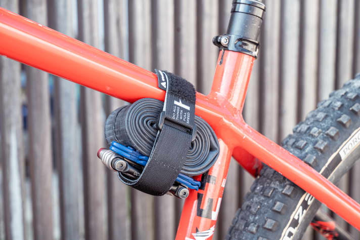 The Rockband strap from Granite is the simplest and cheapest solution for transporting your tools on the frame.