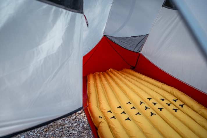 The room height is comfortable. However, there is little space at the side to store your belongings in the tent