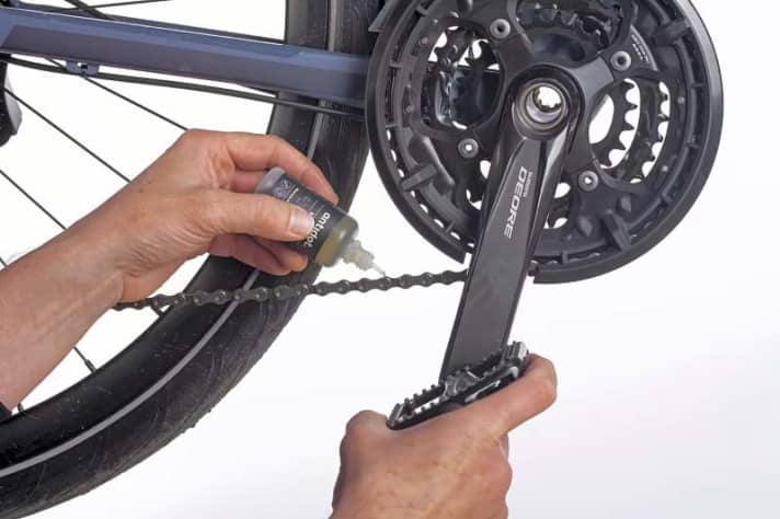Carefully oil the chain while turning it backwards.