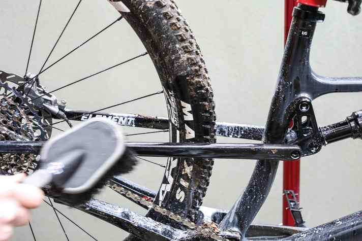Once the cleaner has worked in, remove the remaining dirt with a large brush with long, soft bristles