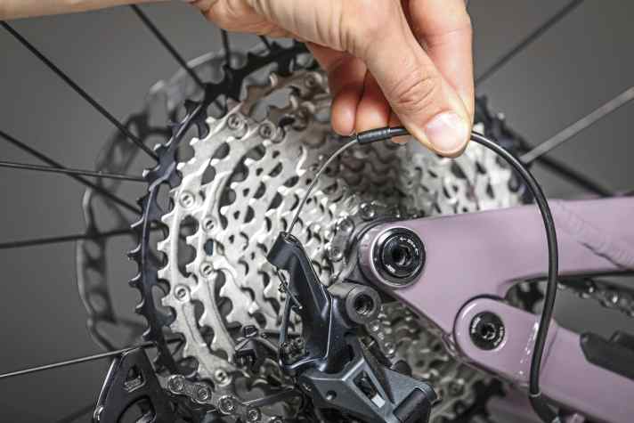 The cable and outer casing can then be unthreaded from the rear derailleur.