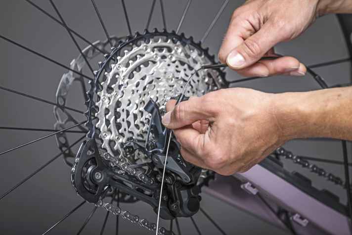 The end cap must also be attached to the outer casing at the rear before the derailleur cable is threaded into the attachment on the rear derailleur.