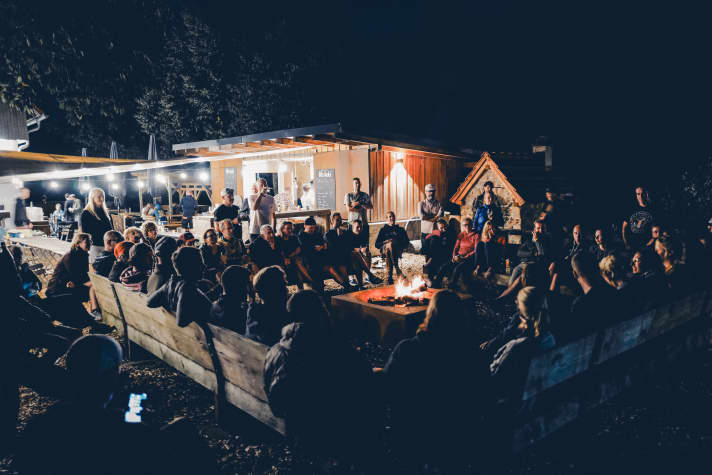 Lively interest in the adventure talk around the campfire.