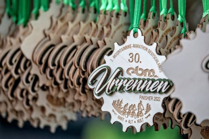 Die traditionelle Finisher-Medaille aus Holz. Jeder EBM hat sein eigenes Motto. Diesmal wurde der Marathon als Urrennen zelebriert.