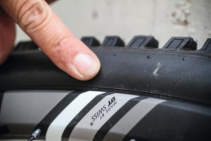 The guide line on the tyre sidewall shows whether it is sitting at the same depth on the rim everywhere.