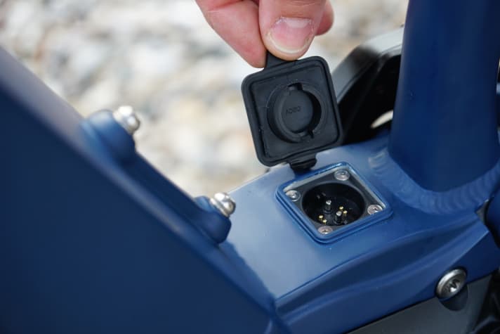   The charging port in the bottom bracket area allows the battery to be charged on the bike. Also in the picture: The MC frames offer space for a bottle cage.