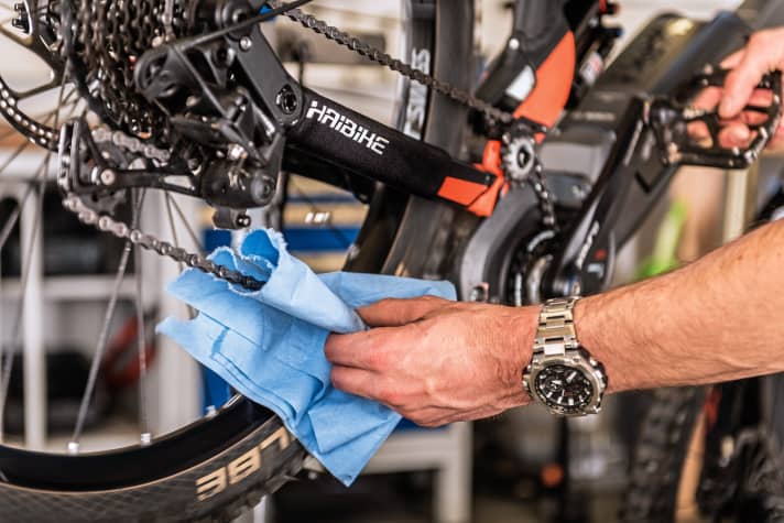   Now clean the chain: Hold a cloth around the chain and turn the crank backwards - this allows the chain to slide through the cloth and be cleaned.    