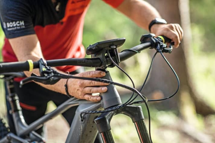   Wobbling back and forth: testing whether the headset bearings still have play.