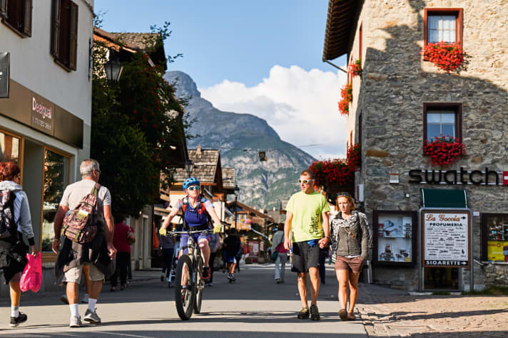   The pretty stone and wooden buildings in Livigno are mostly home to duty-free shops. The façades are adorned with lush geraniums and even more lavish logos. 364 days a year, people shop and refuel here for whatever the border official can just about wave through.