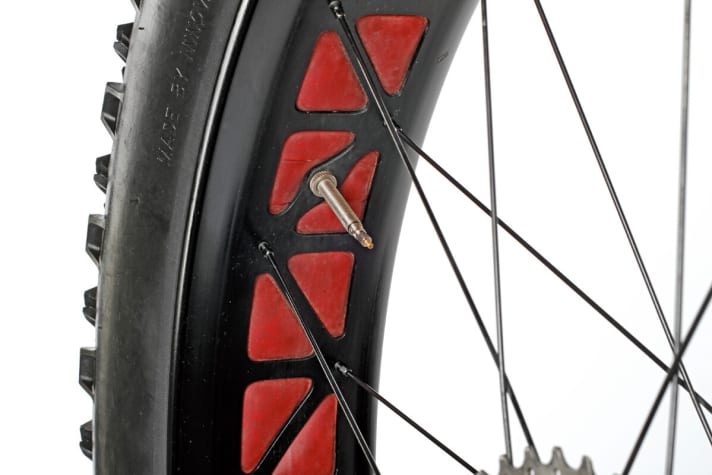 The maximum milled rim keeps the weight low despite the 90 millimetre width. There is no hollow chamber. The inner tube is located directly behind the red rim tape.