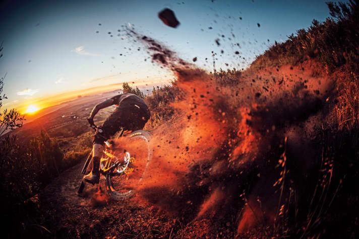  Downhill rush: In the evening light, the horses have run away with the rider. Seconds later, the dust trickles silently back onto the trail.    