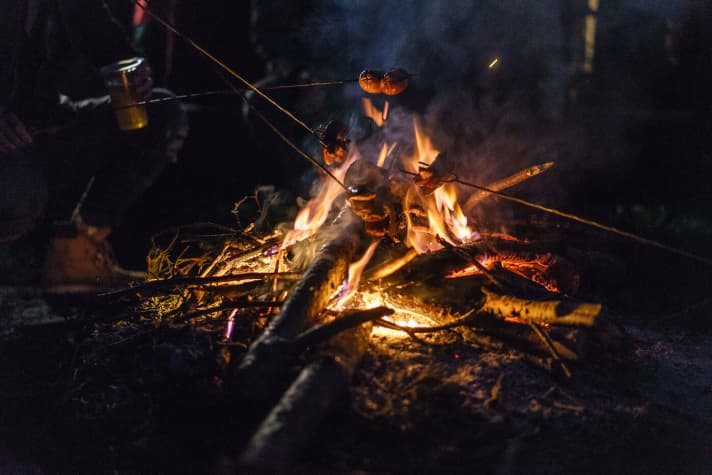   The first day slowly came to an end over a fire.