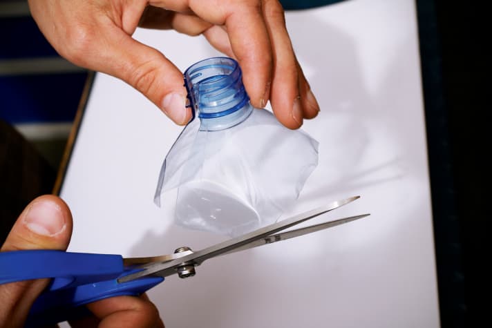   An empty plastic bottle serves as the base for the splash guard.