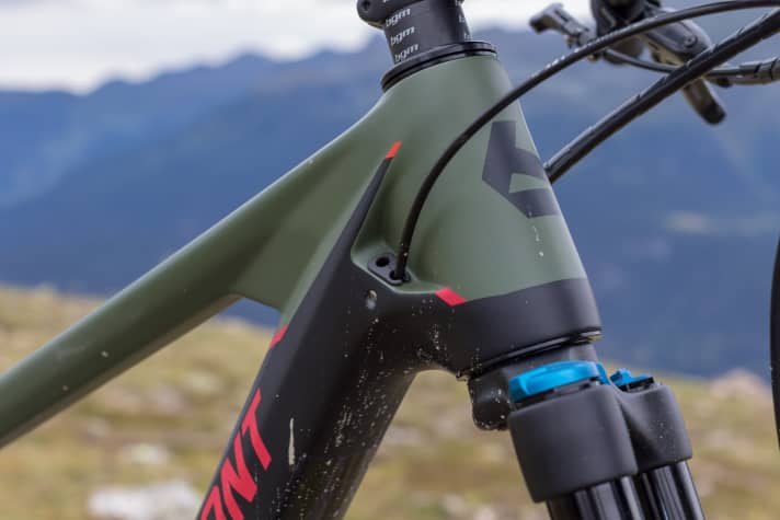   The cables disappear into the angular head tube inside the frame.