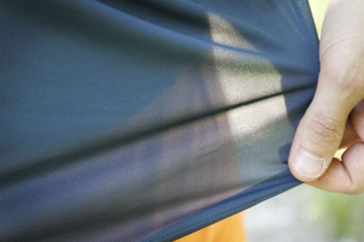   The mesh-like shirt is almost transparent against the light.