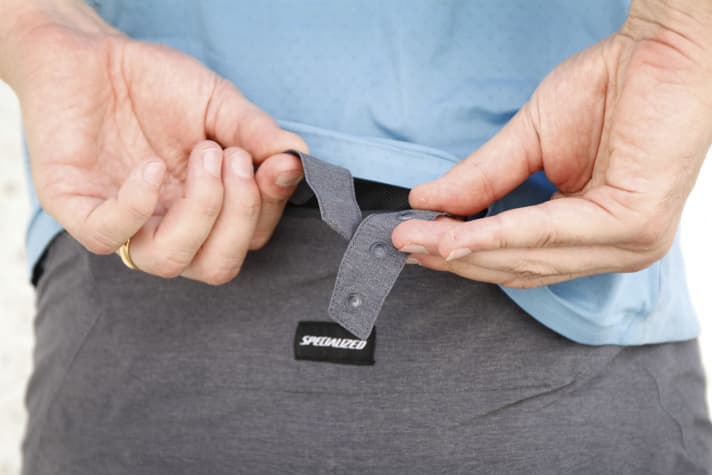   The push-button adjustment is hidden in a zip pocket at the back, is of little use and is difficult to operate without help.