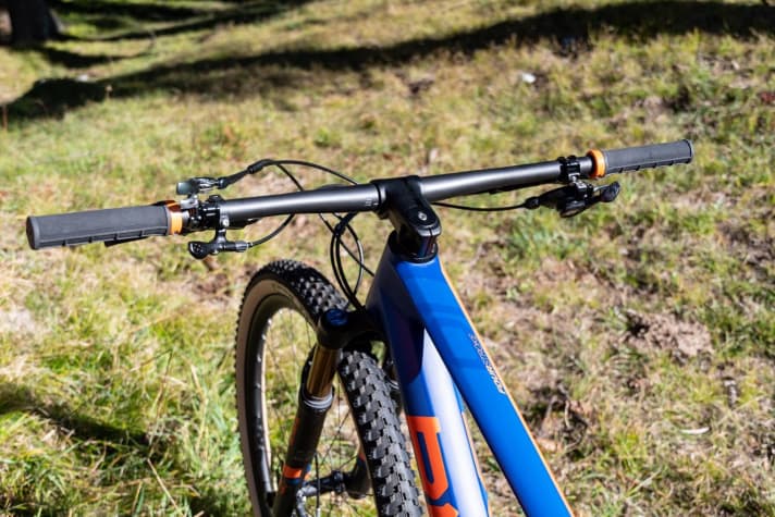   The cockpit of the BMC Fourstroke 01 is noticeably stiff and looks tidy. Wide, straight handlebars, dropper post and lockout on the left, gear lever on the right.