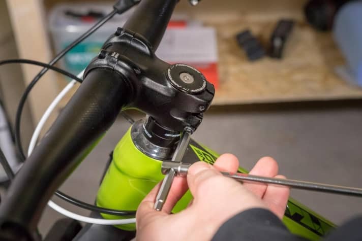   Once it is clear that the headset has play, the next step is to loosen the bolts that clamp the stem to the steerer tube until the stem and handlebars can be turned easily on the steerer tube. One turn of each bolt is often sufficient.
