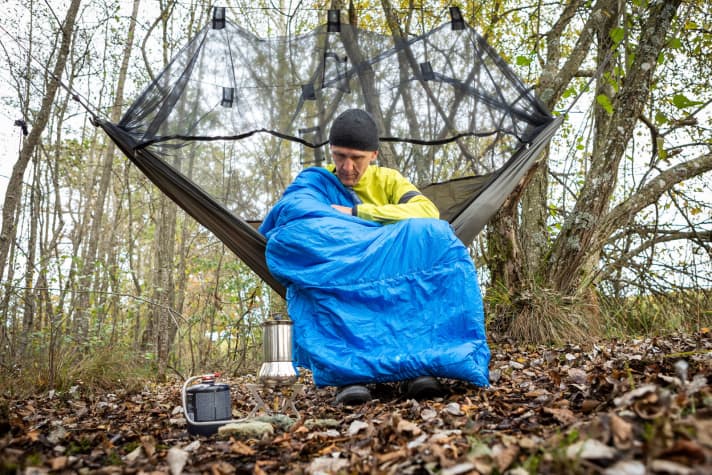 The Vaude Altmann 300 Syn mummy sleeping bag with multi-function is perfect for bikepacking adventures, here simply thrown on as an outdoor blanket.