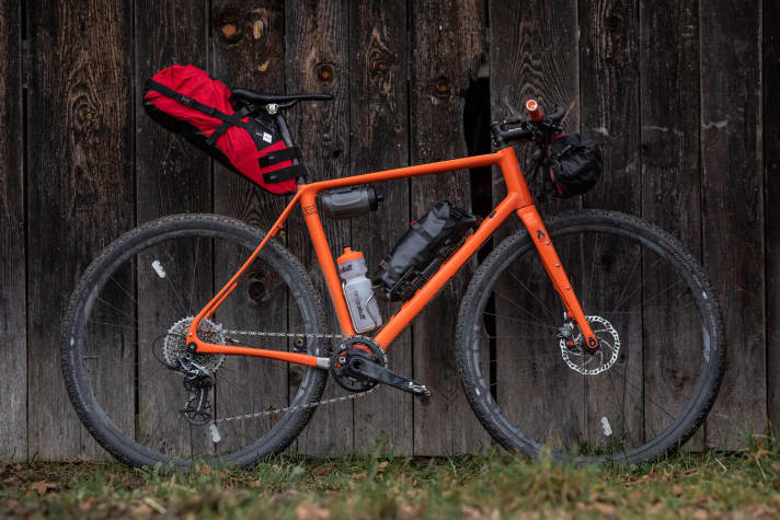   The tent fits securely in the luggage holder on the down tube. The tent pole is attached to the handlebar bag.