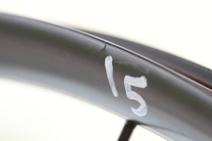   Brittle but strong: carbon withstands impact tests better than aluminium. The material generally does not buckle and withstands harder impacts without damage than aluminium. The picture shows slight delamination after a level five impact.