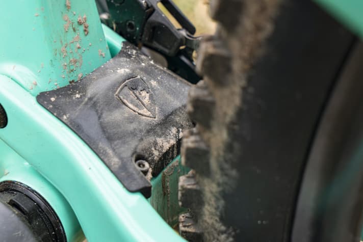   The plastic cover is designed to prevent dirt and stones from getting stuck in the rear triangle.