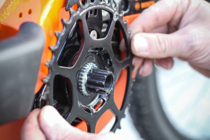 The new chainring is fitted to the greased shaft.